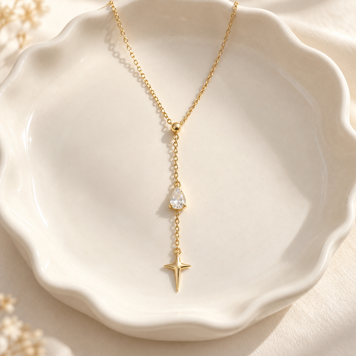 eeablish® Étoile Drop Necklace on ivory ceramic